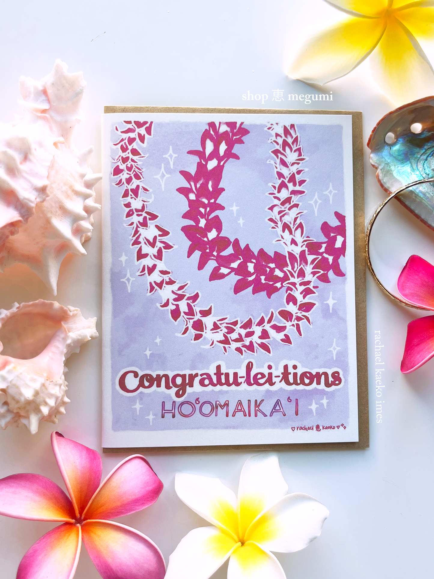 Hawaii-style greeting card with pink floral design and text on a white background with flowers and shells.