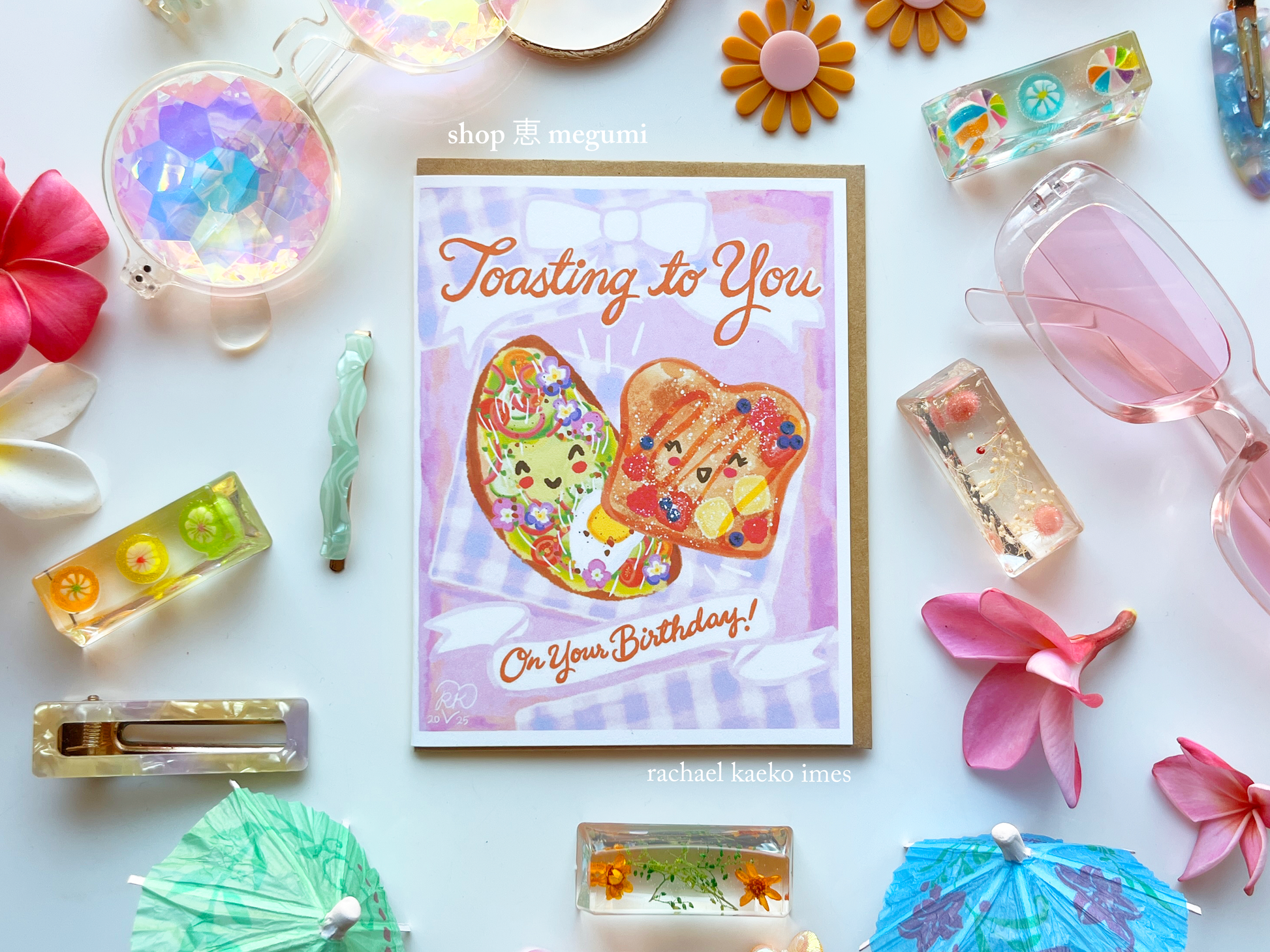 Illustrated avocado toast greeting card with french toast illustration surrounded by decorative items on a white background