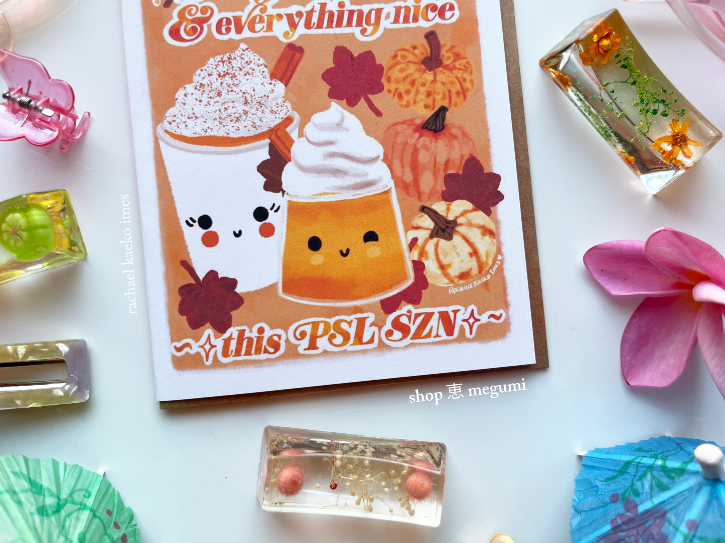 PSL SZN art greeting card with a pumpkin spice latte design and decorative items on a white surface