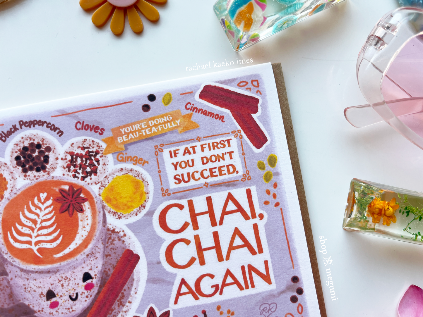 Illustrated chai latte greeting card with 'Chai, Chai Again' text and chai tea-themed illustrations on a white surface.