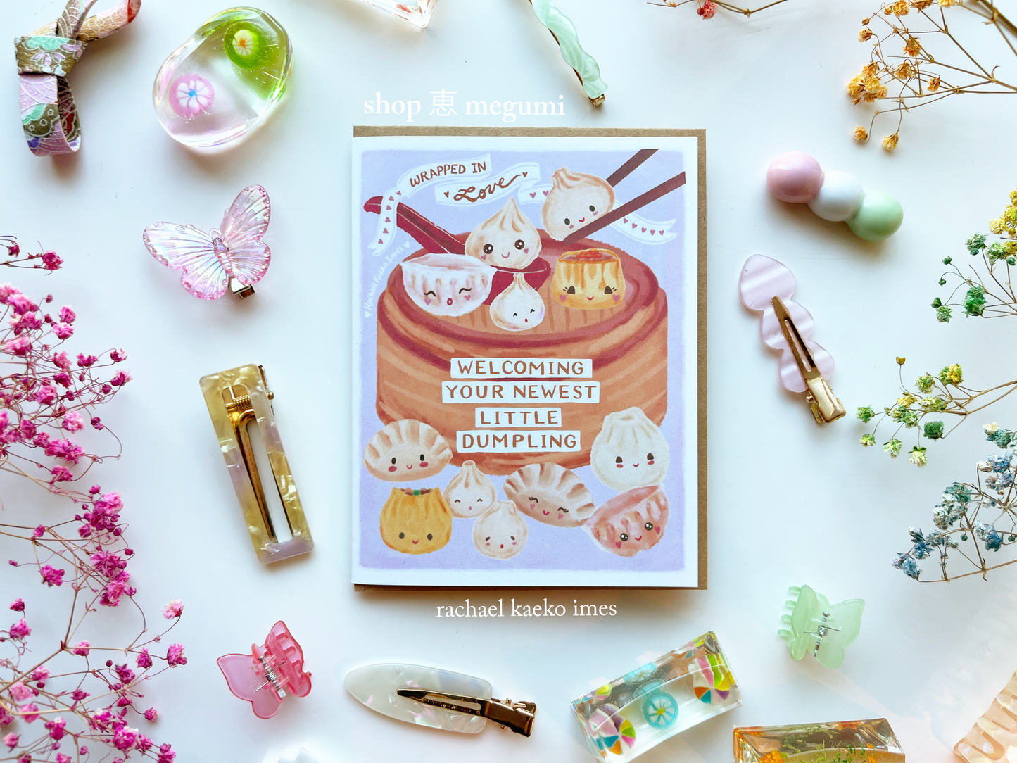 Cute baby shower card with hand-drawn dumplings on a white background with decorative items