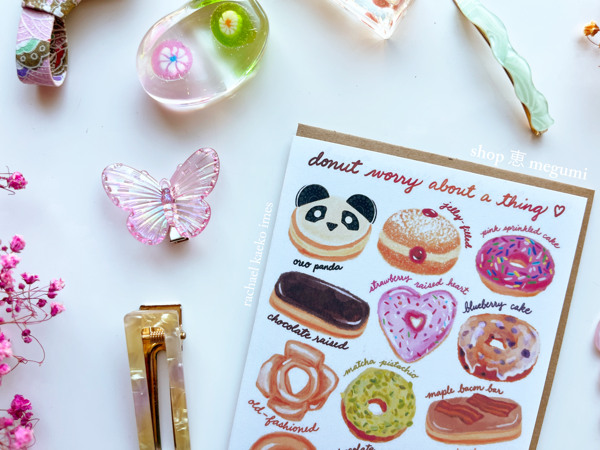 Donut greeting card with donut illustrations on a white surface with decorative items.