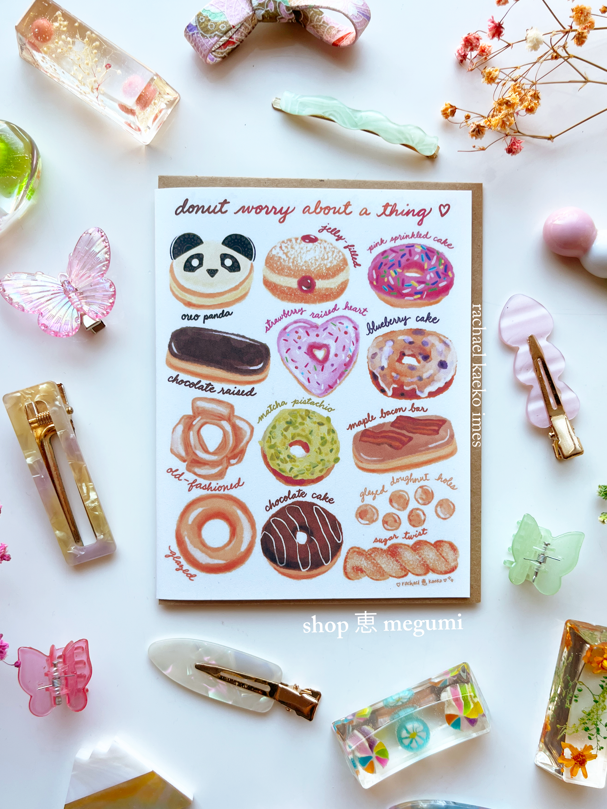 Hand-illustrated greeting card of donut-themed drawings with decorative items on a white background