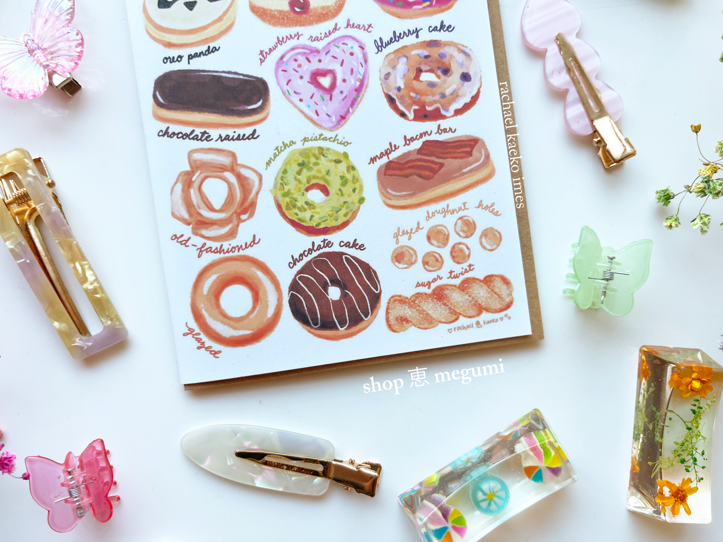 Illustrated donut chart greeting card on a white surface with decorative objects