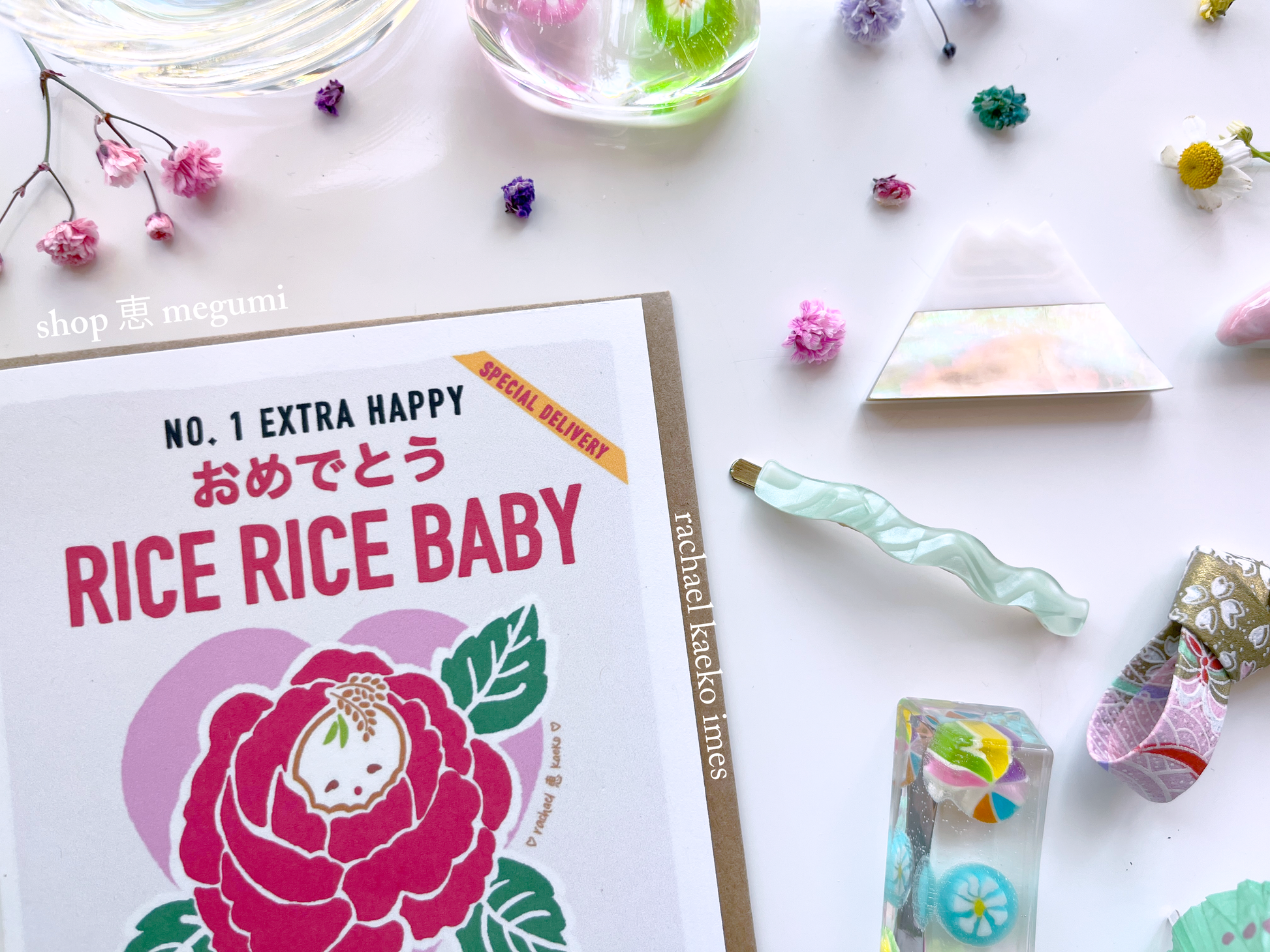 Baby shower card with illustrated floral rice bag design and text that reads "Rice Rice Baby, Congratulations on Your New Bundle of Joy" on a decorative background.