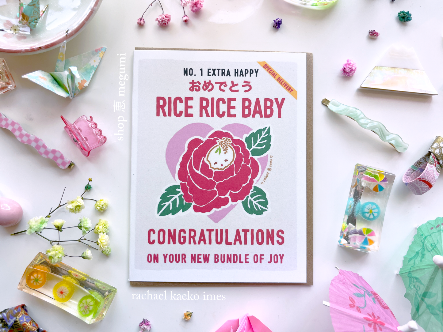 Baby shower card with illustrated floral rice bag design and text that reads "Rice Rice Baby, Congratulations on Your New Bundle of Joy" on a decorative background.